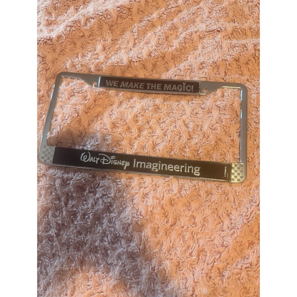 WDI Walt Disney Imagineering “We Make The Magic!” License Plate Frame Rare Metal